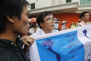 Lawyer Le Quoc Quan (C) holds an Anti-China banner as he chants slogans during an anti-China protest along a street in Hanoi in this July 8, 2012 file photo. Credit: Reuters/Kham